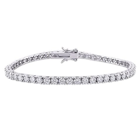 Our sterling silver moissanite tennis bracelet is the definition of eternal. For decades, the tennis bracelet’s iconic infinity design has flawlessly accessorized formal and casual looks. This bracelet blends elegance with a modern sensibility featuring the remarkable dazzle of moissanite. The total diamond equivalent weight is approximately 5 5/8 carats. | Moissanite Tennis Bracelet | Sterling Silver (5 5/8 ct. dew) | White | Size 3.00mm | Helzberg Diamonds Dresses Runway, Silver Lab, Helzberg Diamonds, Wrist Wear, Tennis Bracelet Diamond, Love Ring, Tennis Bracelet, Bracelet Sizes, Silver Bracelets