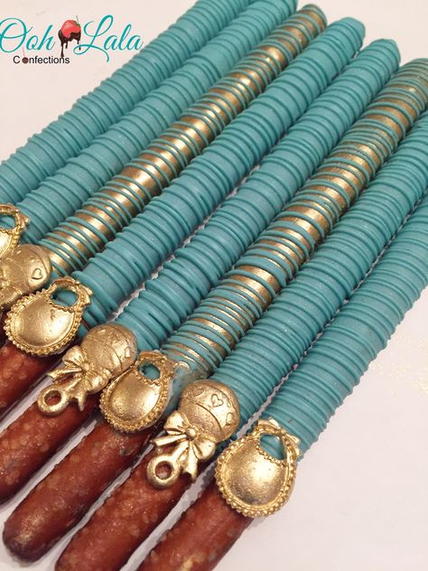 Teal and gold chocolate covered pretzels Brown Desserts, Covered Pretzel Sticks, Chocolate Covered Pretzel Sticks, Baby Shower Desserts Boy, Dipped Pretzel Rods, Chocolate Covered Pretzel, Baby Shower Chocolate, Chocolate Covered Pretzel Rods, Wedding Cake Cookies