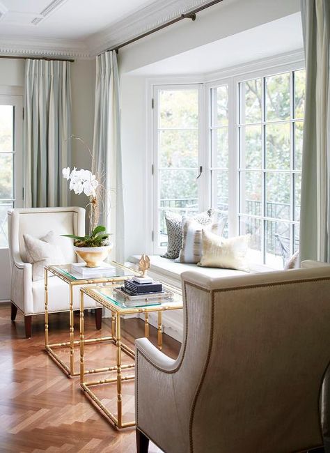 Large bay window bench is decorated with mixed pattern accent pillows on a light gray upholstered cushion. Seating Area Near Window, 2 Chairs By Window, Window Bump Out Interior Ideas, Bay Window Sitting Room, Bay Window Seating Bedroom, Sunroom With Window Seat, Bay Window Seat Curtains, Small Seating Area Ideas, Bay Window Seat Living Room