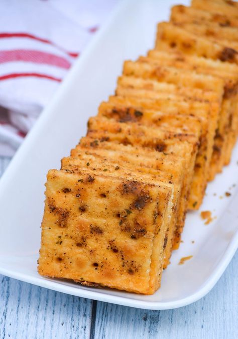 smoked saltine crackers arranged in a row on a small white platter Smoked Saltine Crackers, Marinated Crackers, Cajun Crackers, Spiced Saltine Crackers, Saltine Party Crackers, Fried Saltine Crackers, Chili Crackers, Seasoned Mini Saltine Crackers, Savory Party Cracker Seasoning Recipe