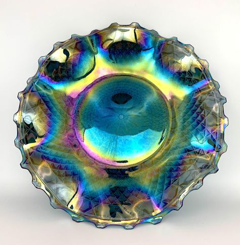 Crafted from exquisite vintage Imperial glass, this platter boasts a stunning iridescent finish that captures light beautifully, ensuring both durability and timeless elegance for your home. The unique mirrored carnival design reflects an array of colors, making it a striking centerpiece for any table setting. Perfect for entertaining guests or simply adding a touch of glamour to your everyday decor. . *Vintage and antique items are not mint, nor are they perfect. Please review all images before purchase. Sold as is and as found (used and vintage) we do not clean the natural patina off but do a light cloth cleaning. These pieces have been previously loved by their original owners, now is your chance to extend the love to your own collection. Carnival Design, Everyday Decor, Imperial Glass, Entertaining Guests, Decor Vintage, Antique Items, Decorative Storage, Table Setting, Decorative Bowls