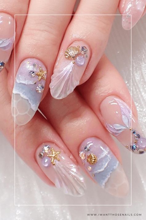 Make a splash this season with these mermaid-inspired nails! Choose from pink, purple, or blue gel or acrylic options, with short or long lengths and a variety of nail shapes. Add some bling to your fingertips and let your inner sea goddess shine with these Mermaid Nails Ideas! Nail Art With Crystals, Ocean Nail Art Sea, Water Nails Acrylic, Sea Shell Nail Designs, Ocean Gel Nails, Nails With Shells, Ocean Acrylic Nails, White Mermaid Nails, Ocean Nails Designs