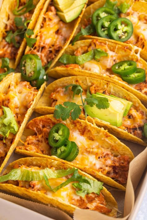 Baked chicken tacos are THE perfect taco night recipe. Quick and oh-so-easy, hard taco shells are stuffed with seasoned, shredded chicken, refried beans, tangy salsa, and shredded cheese, then baked until warm, melty, and deliciously crunchy. Seasoned Shredded Chicken, Taco Shell Recipe, Crunchy Taco Shells, Shells Stuffed, Hard Shell Tacos, Baked Chicken Tacos, Shredded Chicken Tacos, Taco Shells, Chicken Taco Recipes