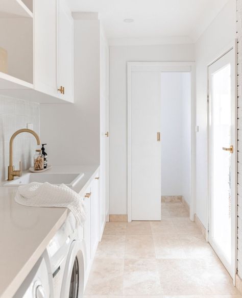 ABI Interiors on Instagram: “A sense of refinement can be achieved by incorporating brushed brass into contemporary coastal settings.⁠ ⁠ The calming scheme takes…” Laundry Layout Design, Finger Tiles Laundry, Laundry Tiles Floor, Laundry Mediterranean, Modern Coastal Laundry Room, Laundry Tile Floor, Mediterranean Laundry Room, Modern Coastal Laundry, Laundry Floor Tiles