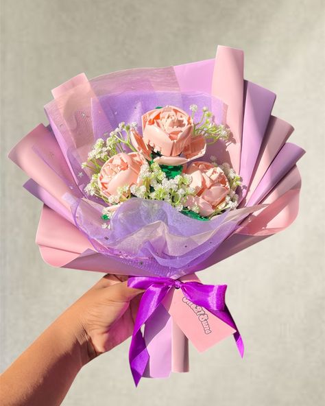 Three large pink roses in lavender / nude pink wrapping, tied together with grape ribbon 🍇 ✨ Our Lego bouquets last forever ❤️Single flowers are $90 TTD and three rose bouquets are $250TTD. Visit our website to order 💖 all bouquets are handmade with love and attention to detail 💖 Nationwide delivery available ✨ #the21suns #legosunflower #legoflowers #legobouquet #eternalflowers Ribbon Flower Bouquet, Forever Single, Ribbon Flowers Bouquet, Luxury Bouquet, Single Flowers, Ribbon Flower, Single Flower, Ribbon Flowers, Nude Pink