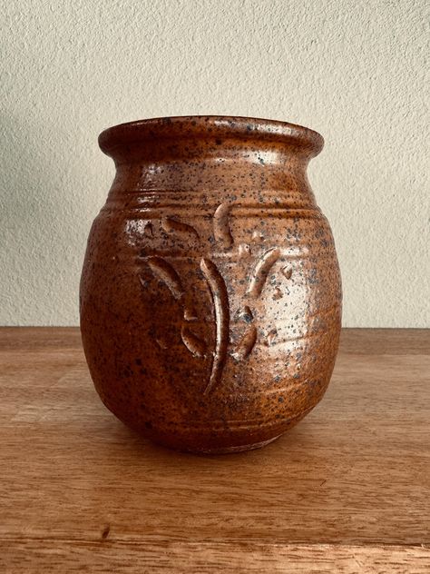 Add warmth and character to your space with this one-of-a-kind handmade studio pottery vase. This rustic, wheel-thrown ceramic piece features a rich brown speckled glaze with an elegant hand-carved floral design, making it a stunning artisan-crafted decor piece. Measuring approximately 5 inches tall and 4 inches wide, this unique pottery vessel is perfect for displaying dried flowers, kitchen utensils, or as a statement piece in any boho, farmhouse, or vintage-inspired home. A beautiful collector's piece or thoughtful gift for pottery lovers. Ships fast! 🎨✨ Dried Flowers Kitchen, Flowers Kitchen, Speckle Glaze, Wheel Thrown Ceramics, Vintage Style Decor, Unique Pottery, Vintage Style Decorating, Boho Farmhouse, Keramik Vase