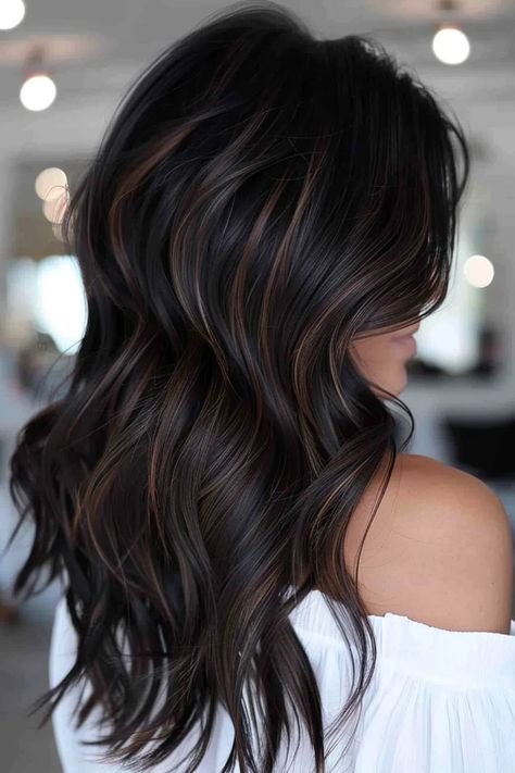 Woman with long, wavy dark hair featuring subtle highlights, wearing an off-shoulder white top. Dark Tone Highlights, Brown And Black Balayage Hair, Black Dark Brown Balayage, Haircut And Highlights For Brunettes, Dark Hair With Black Lowlights, Hair Balayage For Black Hair, Dark Roast Hair, Partial Balayage For Black Hair, Dark Chocolate Caramel Hair