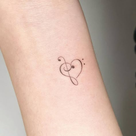 Bass and treble clef heart tattoo on the wrist. Theater Tatoos, Book Music Tattoo, Musical Heart Tattoo, Alto Clef Tattoo, Music Clef Tattoo, Base Clef Tattoo, Fine Line Treble Clef Tattoo, Small Music Tattoos For Women, G Clef Tattoo