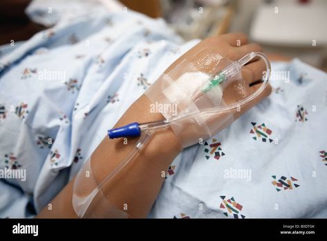 Download this stock image: woman wearing a hospital gown with an IV line and catheter inserted to her hand. - BXDTGK from Alamy's library of millions of high resolution stock photos, illustrations and vectors. Iv Line, Cheer Picture Poses, Stock Photos Woman, Hospital Gown, Cheer Pictures, Image Processing, Picture Poses, Hair Wrap, Photo Image