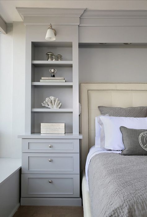 Gorgeous bedroom boasts gray built-in bookcase with lower drawers accented with round brushed nickel pulls lit by a frosted glass wall sconce beside an ivory leather bed with nail-head trim layered with gray bordered bed linens and a gray matelasse coverlet with matching shams. Cabinets Bedroom, Bedroom Built Ins, Transitional Bedroom, Remodel Bedroom, Closet Bedroom, Book Shelf, Beautiful Bedrooms, Dream Bedroom, Bedroom Storage