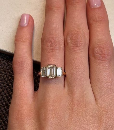 RACHEL BOSTON on Instagram: "A trilogy of striking rub-over set Emerald Cut diamonds form this sleek Deco-inspired ring. We love the proportions of these diamonds that create a stepped effect across the ring finger. ⠀⠀⠀⠀⠀⠀⠀⠀⠀ Tag a friend below who you think would like a Trilogy-style ring like this one 💫↓" Art Deco Trilogy Ring, Albanian Wedding, Bands Rings, Half Bezel, Bezel Engagement Ring, Pretty Accessories, Emerald Cut Rings, Claw Prong, Emerald Engagement Ring Cut