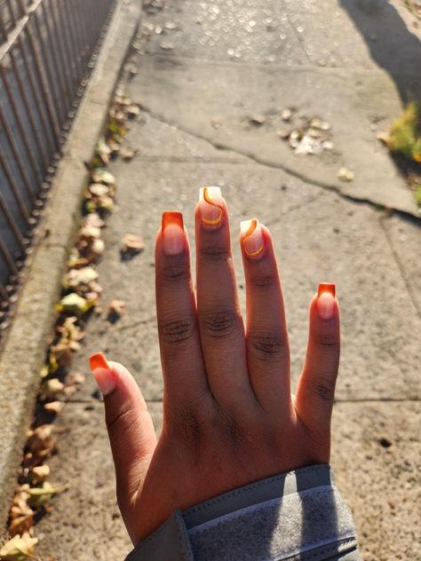 Medium/short length square acrylics. Burnt orange french tips with and yellow and orange swirl designs Medium Length Orange Nails, Burnt Orange Short Nails, Burnt Orange French Tip Nails, French Tip Orange, Dope Nail Designs Short Length, Orange Swirl Nails, Orange French Tips, Square Acrylics, Burnt Orange Nails