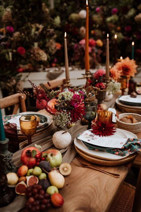 Neutral-toned tablerunner on rustic wooden table, orange, green and red coloured glasses, earthenware, seasonal fruit and vegetables, red, brown and green tapered candles in gold candlesticks and clear vases with autumnal coloured flowers | Nicola Dawson Photography Gold Candlesticks, Glass House Wedding, Autumn Wedding Inspiration, Fall Wedding Tables, Fruit Wedding, Autumnal Wedding, Tapered Candles, Seasonal Fruit, Wedding Tablescape