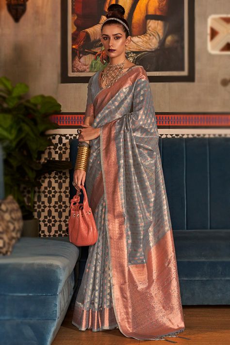 Smartly designed for women on the go, this steel grey tissue saree which makes you appealing.This v-neck and half-sleeve blouse was designed using woven zari work.It is present with a tissue saree in steel grey color decorated using woven zari work.This blouse can be customized up to the maximum size available in inches 44 around the bust. Slight color variation may occur due to photographic reasons.Free Services: Fall and Edging Silk Saree Look, Grey Saree, Fancy Saree, Tissue Saree, Lehenga Choli Online, Half Sleeve Blouse, Blue Saree, Tussar Silk Saree, Gray Silk