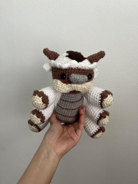 **Handmade Crochet Appa Plushie - Your Loyal Sky Bison Companion ☁️💙   Yip yip! 🥰 Bring home your very own **handmade crochet Appa plushie inspired by the lovable sky bison from *Avatar: The Last Airbender*! Made with soft, high-quality yarn and crafted with care, this cuddly Appa is perfect for snuggling, displaying, or gifting to any Avatar fan. With his fluffy body, signature arrow markings, and gentle expression, he's ready to be your loyal flying companion!   🌿 **Product Details   ✔️ Handmade with yarn 🧶   ✔️ Stuffed with premium fiberfill for extra squishiness ☁️   ✔️ Approx. 7.5 inches - perfect for hugs or display 🤗   ✔️ Detailed embroidery and signature markings for an authentic look ✨   ✔️ A perfect gift for Avatar fans, collectors, and lovers of all things cozy! 🥰   Each A Last Airbender, Sky Bison, Yip Yip, Crochet Toy, Avatar The Last Airbender, The Last Airbender, Amigurumi Crochet, Crochet Toys, Handmade Crochet