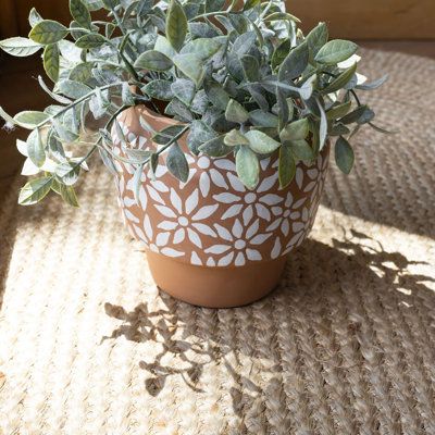 Create a traditional boho aesthetic with this whimsical terracotta pot exclusively from Foreside Home and Garden. Hand thrown by artisans in India, this planter is characterized by a dainty white flower pattern that is hand painted and stands out against the natural terracotta clay background. Add a touch of warmth to your indoor and outdoor spaces. | Foreside Home & Garden Terracotta Pot Planter 6.0 x 6.0 x 6.0 in | AORE5752 | Wayfair Canada Terracotta Pots Front Yard, Terracotta Planter Painting Ideas, Terracotta Pot Paint, Decorated Terra Cotta Pots, Flower Pots Painting Ideas, Terra Cotta Pot Painting Ideas, Thrifted Planters, Painting Planters Pots Ideas, Terracotta Pots Garden