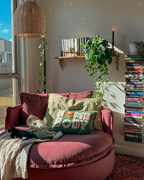 the perfect reading corner doesn’t exi- 🧚🏽‍♀️🍂🎃☕️ guys I love this cozy corner. It’s the perfect size for lounging and reading and naps according to my daughter 😂 I got the @sixpennyhome round daybed in the color summer plum and it’s the perfect pop of color in my room. Thanks to everyone who voted! 🥹 and thank you sixpenny for sending my dream chair over! 💟 update: I am currently in my vampire era and I am enjoying fang fiction! I finished so thirsty & had an amazing time. I have to rea... Small Comfy Chairs For Bedroom Corner, Colorful Reading Corner, Reading Nook Simple, Lounge Room Inspiration, Moody Reading Corner, Chair In Bedroom Aesthetic, Boho Chairs Bedrooms, Cozy Corner Bed Ideas, Book Room Aesthetic Cozy