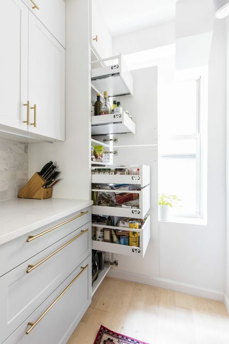 Opposite the new fridge, a floor-to-ceiling pantry with pull-out drawers provides plenty of space for dry goods storage. End Stove Kitchen Layout, Small Double Galley Kitchen Ideas, Microwave In Ikea Pantry, Cute Kitchens Apartments, Tiny Galley Kitchen Ideas Cottage, White And Gold Galley Kitchen, Galley Kitchen Double Oven, Small Galley Kitchen Remodel On A Budget, Fridge Next To Stove Kitchen Layouts