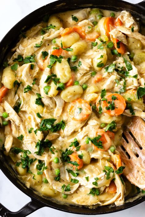 Shredded chicken, gnocchi, and a mirepoix of vegetables in a creamy sauce are the heart and soul of this simple, cozy, 30-minute dinner recipe.