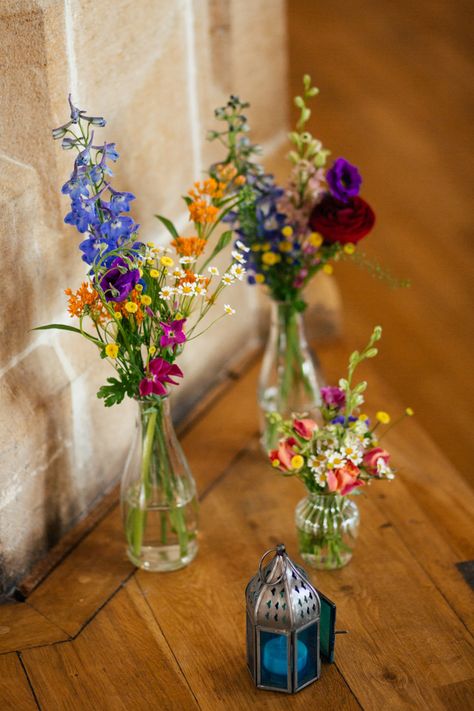 Rainbow Colourful Bottle Flowers Wild Natural Decor Multicoloured Fun Creative Wedding http://www.catlaneweddings.com/ Lanterns Paper, Boda Mexicana, Wedding Table Flowers, בר מצווה, Whimsical Wonderland Weddings, Trendy Flowers, Wildflower Wedding, Wedding Table Centerpieces, Table Flowers