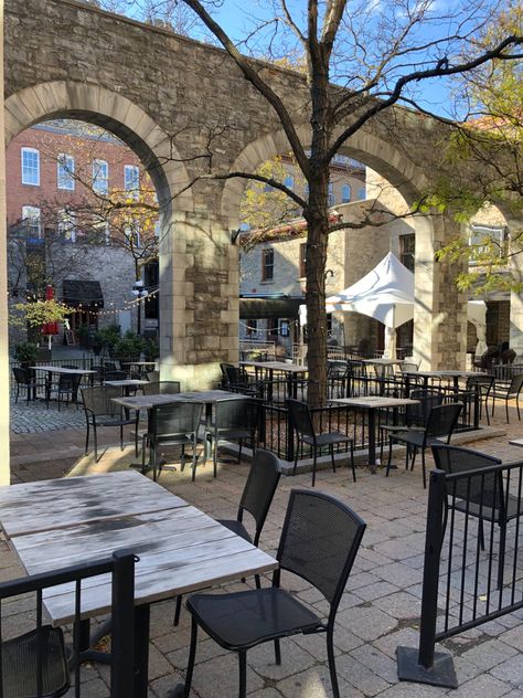 An outdoor restaurant in downtown Ottawa. There are some tables, some chairs, some trees and a portal dividing the restaurant in two. Ottawa Restaurants, Downtown Ottawa, Outdoor Restaurant, Ottawa, Restaurant, Patio, Outdoor Decor, Quick Saves, Home Decor