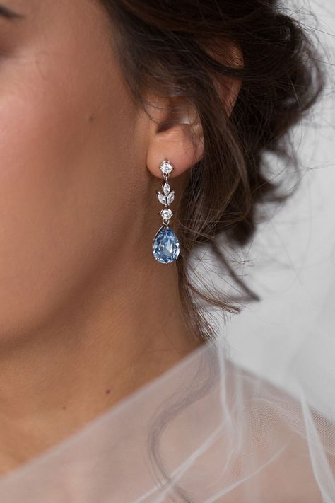 Bride wearing a long teardrop bridal earring with blue crystals Silver Formal Earrings, Blue Earrings Aesthetic, Jewellery For Bride, Swarovski Drop Earrings, Earring Pendant Set, Blue Earrings Wedding, Light Blue Necklace, Bridal Jewellery Set, Blue Wedding Jewelry