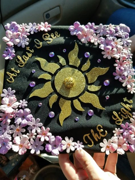 My daughter decorated her graduation cap with a Tangled Theme. I think it's beautiful! Grad Cap Designs Tangled, Tangle Graduation Cap, Graduation Cap Rapunzel, Repunzal Graduation Cap, Disney Theme Graduation Cap, Disney Cap Decoration Graduation, Sun Graduation Cap, Disney Princess Grad Cap, High School Grad Cap Ideas Disney