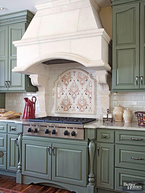 The ornate mosaic tile installation above this cooktop evokes country French style with an edge. The focal point delivers flourishes of pink that pick up the color of the kitchen's window shades. Arched Vent Hood Ideas, Interesting Backsplash Ideas, Kitchen Arches, Arched Backsplash, Country Kitchen Backsplash, Creative Backsplash, Stove Hood, Neutral Backsplash, Rustic Backsplash