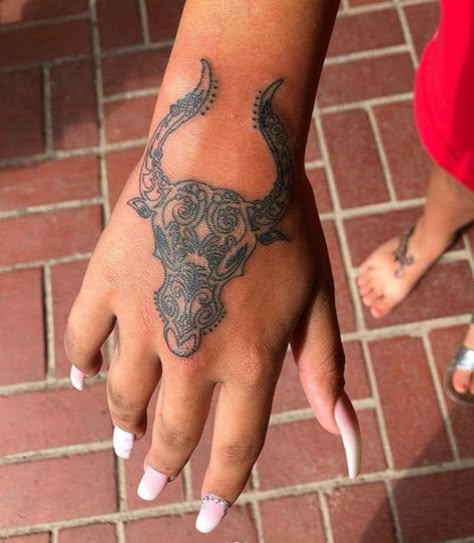 50+ Taurus Tattoo Designs And Ideas For Women (With Meanings) Taurus Tattoo Hand, Taurus Hand Tattoos For Women, Taurus Bull Tattoos For Women Leg, Taurus Woman Tattoo, Bull Tattoo Feminine Taurus, Taurus Hand Tattoo, Small Taurus Tattoo, Taurus Tattoo Ideas For Women, Taurus Bull Tattoo