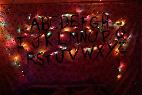 Stranger Things Wall & Fairy Lights. Halloween Party. Done by hanging up a piece of fabric bought from a local store, letters painted on with acrylic black paint & battery powered fairy lights pinned on sporadically. Wall Fairy Lights, Fairy Lights On Wall, Stranger Things Wall, Wallpaper Full Hd 4k, Battery Powered Fairy Lights, Wallpaper Full Hd, Full Hd 4k, Stranger Things Wallpaper, Strange Things