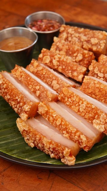 Derek Chen on Instagram: "Lechon Kawali Ingredients * 4 lbs pork belly * 1 red onion(quartered) * 10 cloves garlic(smashed) * 4 bay leaves * 1 tbsp black peppercorns * Salt * 1/4 cup vinegar * 2 tbsp fish sauce * Water * Oil for frying Instructions 1. In a pot add pork belly, red onion, garlic, bay leaves, black peppercorns, 2 tsp salt, vinegar, and fish sauce. 2. Cover with water, bring to a boil, then lower the heat and simmer for 45 minutes. 3. Remove the pork belly and pat it as dry as pos Lechon Sauce, Asian Food Photography, Lechon Kawali, Deep Fried Fish, Fried Pork Belly, Cooking Tutorials, Red Onions, Asian Desserts, Bay Leaves