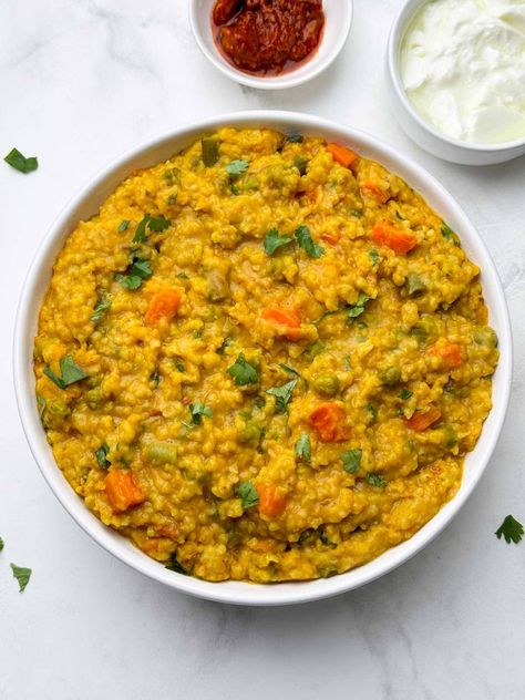 vegetable dalia khichdi (broken wheat khichdi) served in a bowl with pickle and yogurt on the side Khichdi Recipe, Khichdi Recipe Indian, Dal Khichdi Photography, Easy Khichdi Recipe, Dal Khichdi, Dalia Recipe Indian, Dalia Khichdi Recipe, Khichdi Recipe Indian Instant Pot, Daliya Khichdi