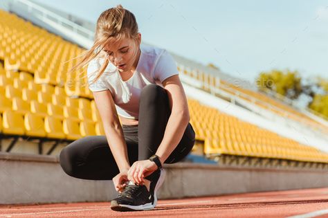 Fitness woman tie shoelaces by vadymvdrobot. Portrait of a fitness woman tie shoelaces at outdoor stadium Take The Stairs, Strict Diet, Increase Metabolism, Women Ties, Tie Shoelaces, Female Photographers, Do Exercise, Athletic Men, Photo Tips