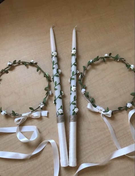 "Rustic Greek Orthodox Wedding Crowns. A natural rustic delicate pair of stefana that is sure to keep all eyes on you on your big day. These lovely bridal crowns are handmade with silver plated flexible wire, wrapped with twine, green vine ribbon and finished with delicate white rose buds. The crowns are attached with double sided satin ribbon. 7\" diameter The stefana represent the connection of two people, the rings that connect the chains of their lives. The orthodox church uses the stefana t Christening Giveaways, Traditional Greek Wedding, Orthodox Wedding Candles, Greek Wedding Candles, Orthodox Wedding Crowns, Greek Wedding Traditions, Greek Crown, Baptismal Candle, Greek Orthodox Wedding