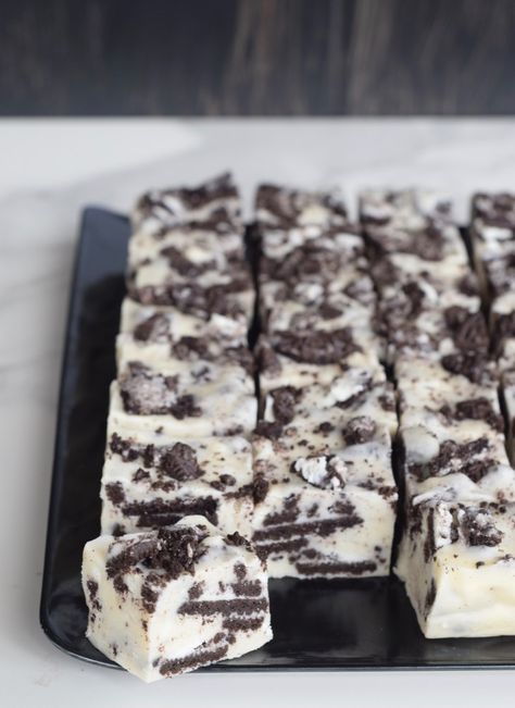 Cookies n Cream White Chocolate fudge on a black platter is so rich it goes a long way for gift giving Cream Fudge Recipe, White Party Foods, Cookies And Cream Fudge, Graduation Treats, Cream Fudge, Cookies N Cream, White Chocolate Fudge, White Desserts, Marshmallow Cream