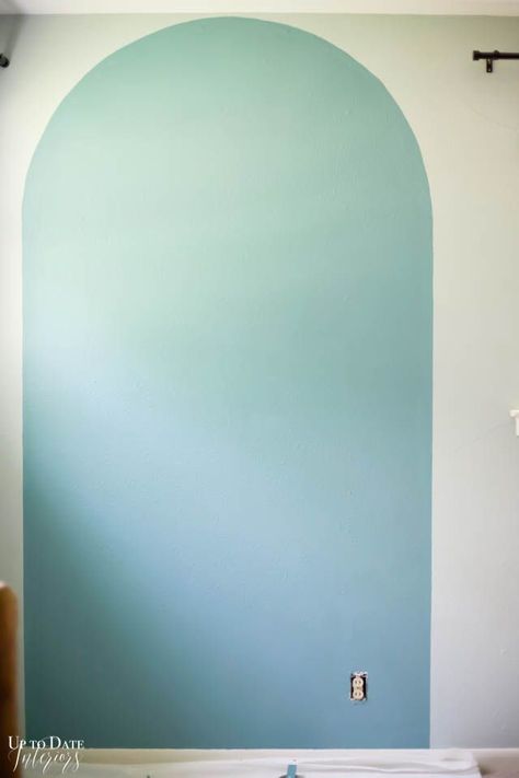 Change your room in an afternoon with a DIY painted arch accent wall and update a piece of furniture in the same color for a big impact! Head over to uptodateinteriors.com to see step by step instructions and video. #sponsored Paint Arches Bedroom, Arched Wall Painting, Painted Arch Feature Wall, Arch Design On Wall, Painted Arch Accent Wall Nursery, Diy Painted Arch On Wall, How To Paint Arch On Wall, Diy Geometric Wall Paint Patterns, Diy Painting Walls Ideas