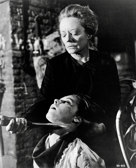 Tallulah Bankhead holds Stefanie Powers captive with a knife against her throat in a scene from the film 'Die! Die! My Darling!' (Columbia Pictures-Hammer Pictures, 1965) Directed by Silvio Narizzano Holding Knife To Throat Pose, Holding Knife Above Head Reference, Throat Aesthetic, Knife To Throat Pose Reference, Knife To Throat Art, Woman Holding Knife Reference, Knife Against Throat Reference, Someone Holding A Knife, Poses With Knife