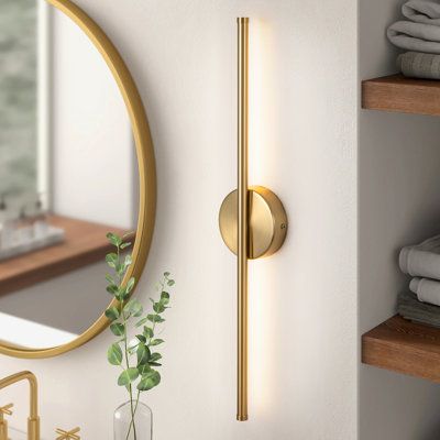 Full of sleek, modern minimalism, this semi-flush mounted sconce illuminates almost any spot you could think of in your home. Crafted from iron with a bold finish, it features a circular backplate and a bar that can be installed vertically or horizontally, depending on your available space and aesthetic. Built into the rod is an LED strip that faces against the wall, casting a bold and dimmable glow in your bedroom or over your bathroom vanity. Our favorite part? This wall light is rated for dam Sconces Bathroom Lighting, Gold Wall Sconces Bedroom, Bathroom Wall Sconces Double Vanity, Dining Room Wall Sconces, Mid Century Modern Sconces, Florida Bedroom, Terrazzo Bathroom, Gold Sconces, Stripped Wall