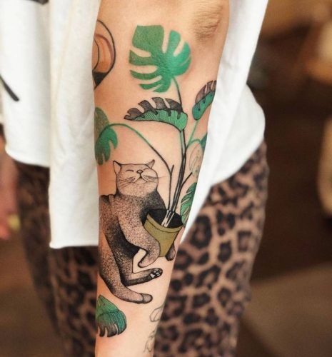 Explore 20 Lush Tropical Leaves Tattoo Ideas - Perfect for Nature Lovers in 2024 Cat And Monstera Tattoo, Plant Cat Tattoo, Plant Tatoos, Monstera Deliciosa Tattoo, Houseplant Tattoo, House Plant Tattoo, Monstera Tattoo, Tropical Tattoo, Funny Tattoo