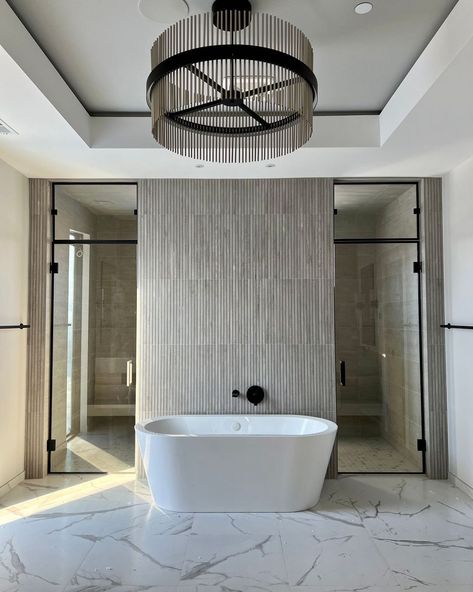 Dawn Reeves Design on Instagram: “One of my favorite bathrooms to date! The tile backsplash behind the tub adds a striking textural detail. The drywall soffit defines the…” Master Bath With Shower Behind Tub, Tile Behind Bathtub, Double Entry Shower Master Bath, Tub Backsplash, Tile Combinations Bathroom Master Bath, Transitional Modern Bathroom, Shower Behind Tub, Bathtub Backsplash Ideas, Ribbon Tile Bathroom