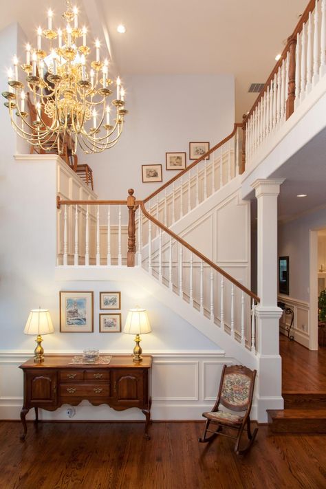 Every good entry makes a statement, setting the tone for the rest of the home. The basic builder-grade staircase in this entry has been updated with traditional paneling, and the basic square post is wrapped with crown molding and base trim detailing. Traditional Colonial Kitchen, Traditional Entryway, Foyer Staircase, Colonial Kitchen, Traditional Staircase, Storage Inspiration, Traditional Colonial, Up House, House Stairs