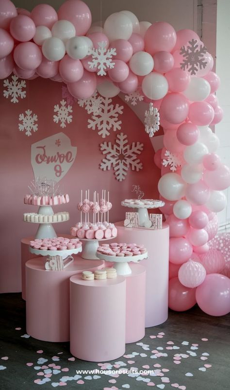 Consider going for a classical vibe, this is a lot easier to set as you are going to combine easy elements to use as the backdrop. This winter baby shower uses paper snowflakes, a balloon stand, and a cookie stand. This is a really simple winter wonderland theme but also sophisticated. Baby Shower Snowflake Theme, Pink Winter Wonderland Party, Snowflake Baby Shower Ideas, Pink Winter Wonderland Baby Shower, Wonderland Baby Shower Ideas, Winter Wonderland Baby Shower Ideas, Pink Winter Wonderland, Baby Shower Images, Balloon Stand