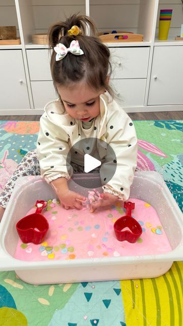 Desiree Blanchard, M.H.K | Baby & Toddler Play on Instagram: "🌈💗Easy conversation hearts sensory bin play idea!!! ✨FOLLOW✨ @lovebloomlearn for more easy play ideas! 

To recreate, add some cornstarch to a shallow bin, mix pink food colouring in water and add water to the cornstarch. If the mixture is too stiff, add more water, or if it’s too runny, add more cornstarch. Mix until blended. You may have to use your hands. Add some conversation hearts with measuring cups! Have fun! 🥰

Waterproof mat is from @rudienudie_designs - use code lovebloomlearn for a discount! 

Bib from @neferland_baby - use code lovebloomlearn for a discount! 

➡️ Check out my “Baby and Toddler Activities and Milestones Caregiver Guides” for easy play ideas! - link in bio! ✨

👶🏼👶🏽👶🏾 An adult should supervise Pink Colour Activity For Preschool, Sensory Bin Play, Pink Food, Pink Food Coloring, Conversation Hearts, Food Colouring, Sensory Bin, Toddler Play, Converse With Heart