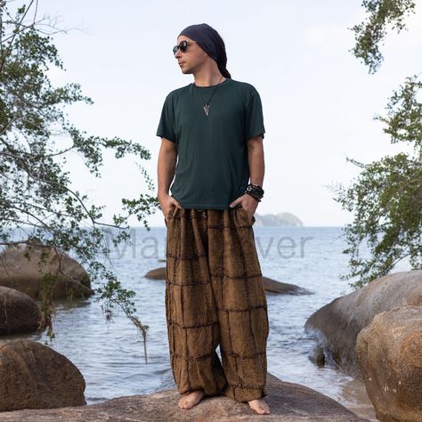 MarxSilver Embrace effortless boho style with these exotic patchwork harem pants for men.  - Handmade construction spotlights artisan fabrics in vibrant global prints   - Custom fit with elastic waist, adjustable ties and button hem - Roomy silhouette and soft fabric provide superior comfort and ease The globally-inspired patchwork patterns make these harem pants an eye-catching addition to your wardrobe. With their laidback vibe and exotic flair, you'll turn heads whether at the studio, beach o Boho Pants Men, Men Boho Outfit, Earthcore Outfits Men, Men Hippie Outfits, Boho Outfit Men, Boho Fashion Men, Boho Outfits Men, Mens Hippie Fashion, Hippie Guy