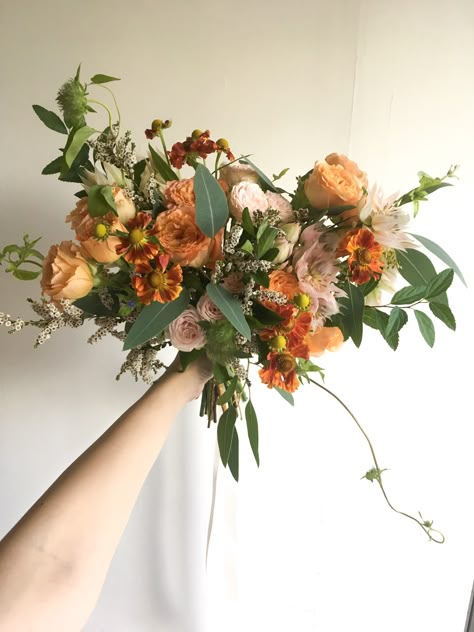 Wedding Bouquets Orange And Green, Dark Green And Orange Flowers, Orange And Green Wedding Florals, Peachy Orange Wedding Flowers, Orange And Green Summer Wedding, White Green Orange Bouquet, Wildflower Bouquet Orange, 70s Flower Bouquet, Pink Orange Green Color Scheme Wedding