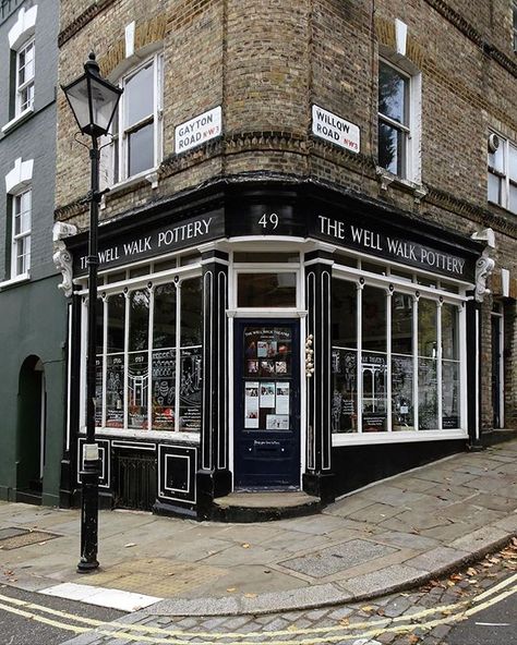 The Well Walk Pottery London @monica.orion.7 Thank you for sharing the history of this beautiful Victorian corner shop - a former grocery store then a pottery shop since the 1950s will be reimagined next year as a children's bookshop cafe and theatre #shopfront #shopcorners #sharingaworldofshops . . .  #wellwalkpottery #london #tskmapslondon #cornershop #chasingfacades #prettyshopfronts #theshopkeepersmaps #tskmapslondon #prettycitylondon #potteryshop #blackshopfront #ihavethisthingwithshops #sh Bookshop Café, Corner Shop, Shop Fronts, Pottery Shop, Shop Front, Victorian Gothic, Shop Window, London City, The 1950s