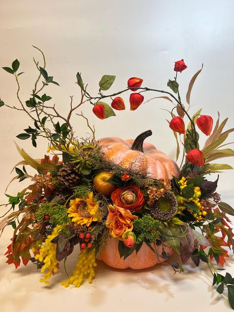 Beautiful unique large artificial fall arrangement  a real show stopper! Made with, berries, roses, chrysanthemums, greenery, pine cones, sunflowers, moss about 24"  wide and 20" tall and  18 " in diameter Foam Pumpkin Floral Arrangement, Artificial Pumpkin Centerpieces, Large Autumn Floral Arrangements, Unusual Floral Arrangements Ideas, Fall Vase Decor, Harvest Centerpieces, Autumn Floral Arrangements, Halloween Florals, Thanksgiving Flower Arrangements