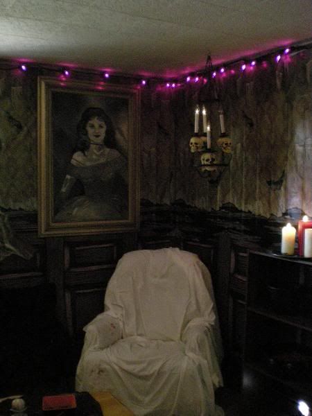 The purple lighting is a nice touch for this haunted scene. Ghost Room Haunted House, Scary Doll Room Haunted House, Abandoned House Decorations, Haunted Manor Halloween Decor, Creepy Haunted House Ideas, Scary Hotel Aesthetic, Basement Haunted House Ideas, Haunted Dining Room, Haunted Ballroom Decorations