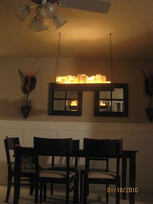 I don't know about this DIY version, but we saw an actual one at Lowe's which we liked. Total Cost: $32.50    Cups: $12 (1.92 for a 4 pack at WalMart)    Contact Paper $6    Scrap wood $0.50    Trim - $7    Hardware (chain and hooks) $7 Candle Chandelier Diy, Faux Candle Chandelier, Pillar Candle Chandelier, Faux Candles, Dining Chandelier, No Sew Curtains, Hanging Candles, Modern Chandeliers, Diy Chandelier