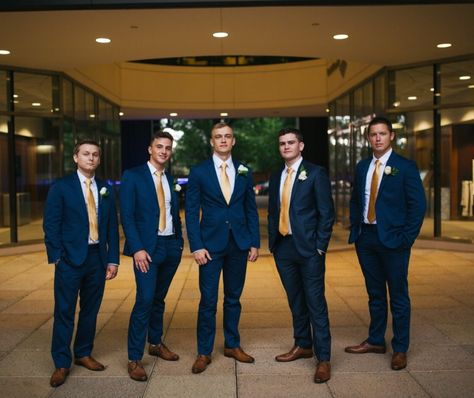 Grooms navy suits and gold ties ! Navy Suit Gold Tie Wedding, Navy Blue Suit With Gold Tie, Navy And Gold Suit Wedding, Navy Blue And Gold Suit Wedding, Blue And Gold Chambelanes, Navy Blue And Rose Gold Tuxedo Wedding, Navy Blue And Gold Suit Men, Navy Blue And Gold Wedding Party, Navy Blue And Gold Groomsmen Suits